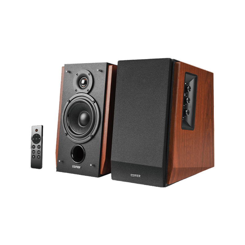 Pair of speakers with wooden finish and remote control on a white background